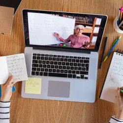 High angle view of video conference with teacher on laptop at home. College student learning maths while watching online webinar, listening audio course. Top view of girl in video call with personal tutor on computer, distance and e-learning education concept.